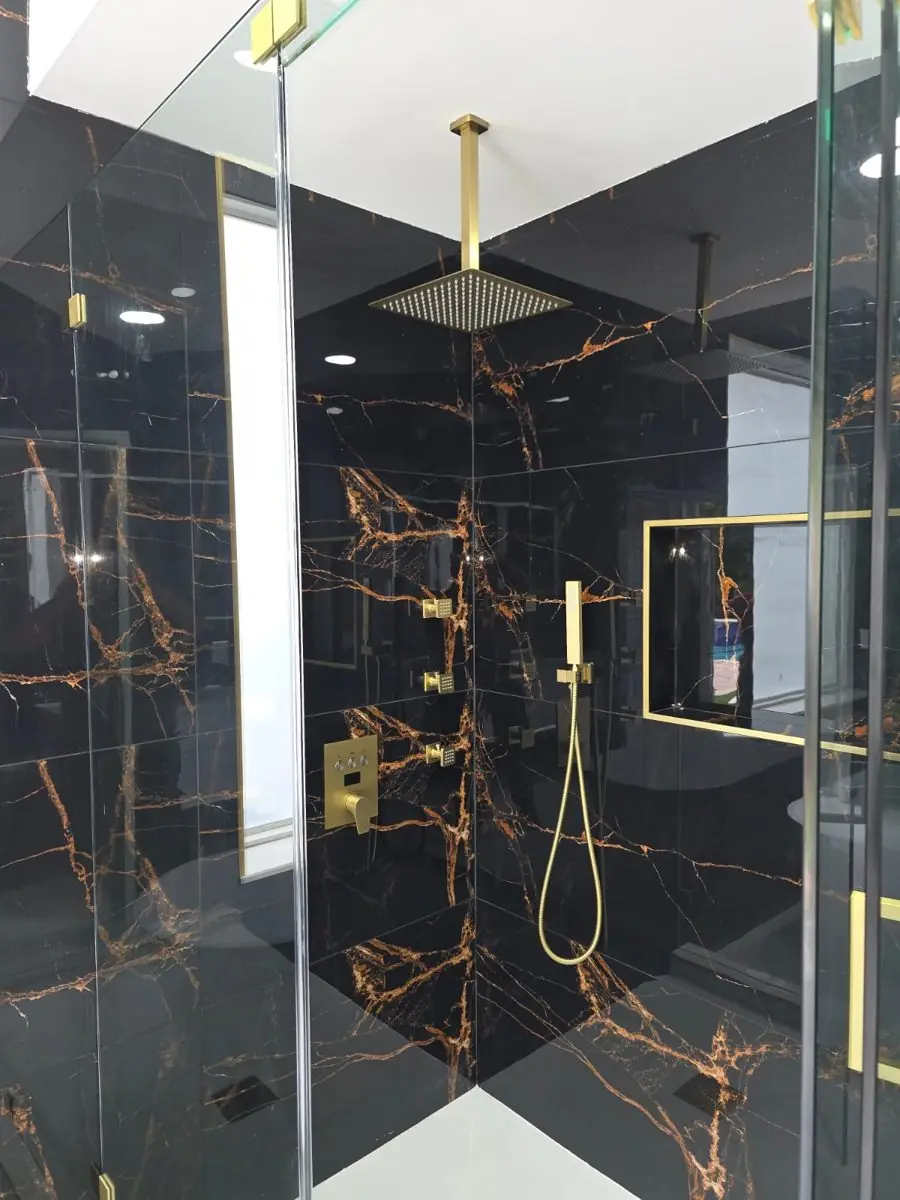 Black and gold master bath — Bathroom remodel by Proper Roofing