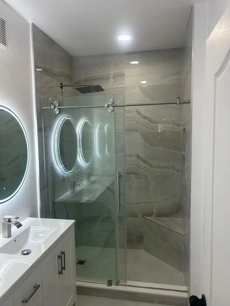 Onyx-look shower with bench — Bathroom remodel by Proper Roofing