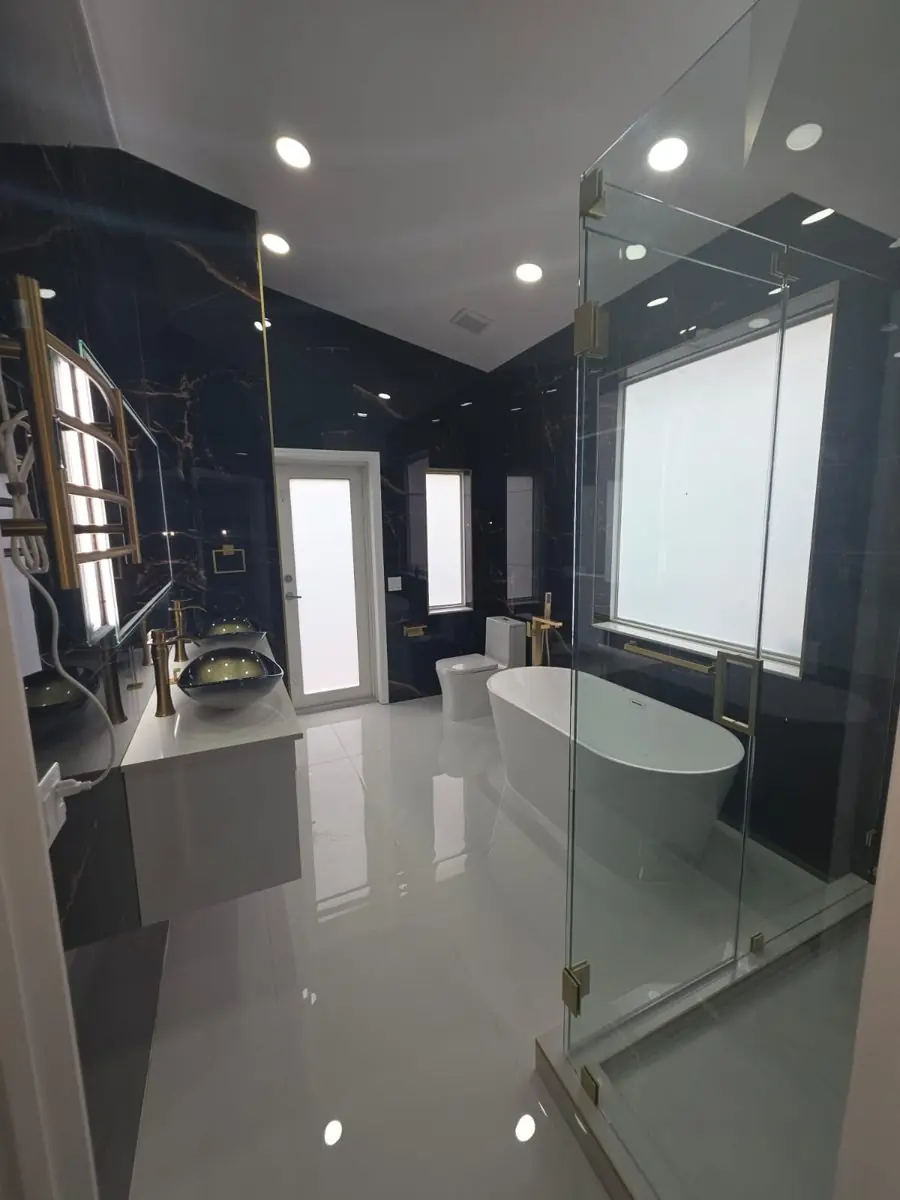 Black and gold master bath — Bathroom remodel by Proper Roofing