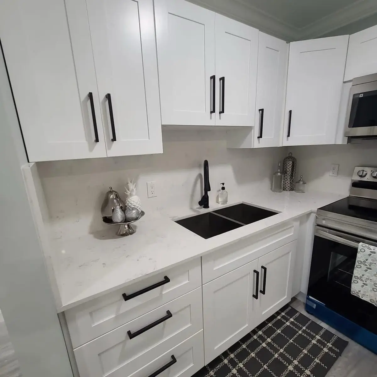 White shaker, matte-black hardware — Kitchen remodel by Proper Roofing