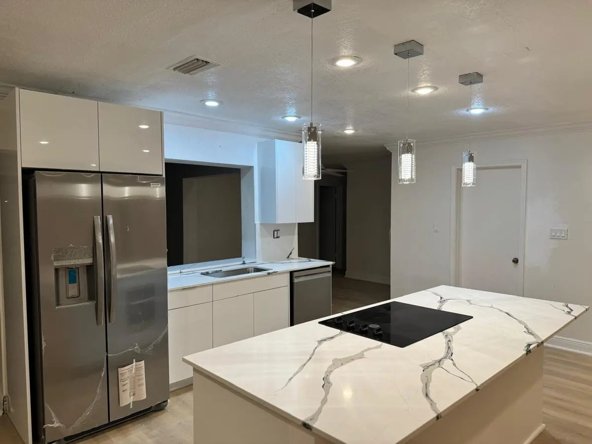 Open kitchen with quartz island — Kitchen remodel by Proper Roofing
