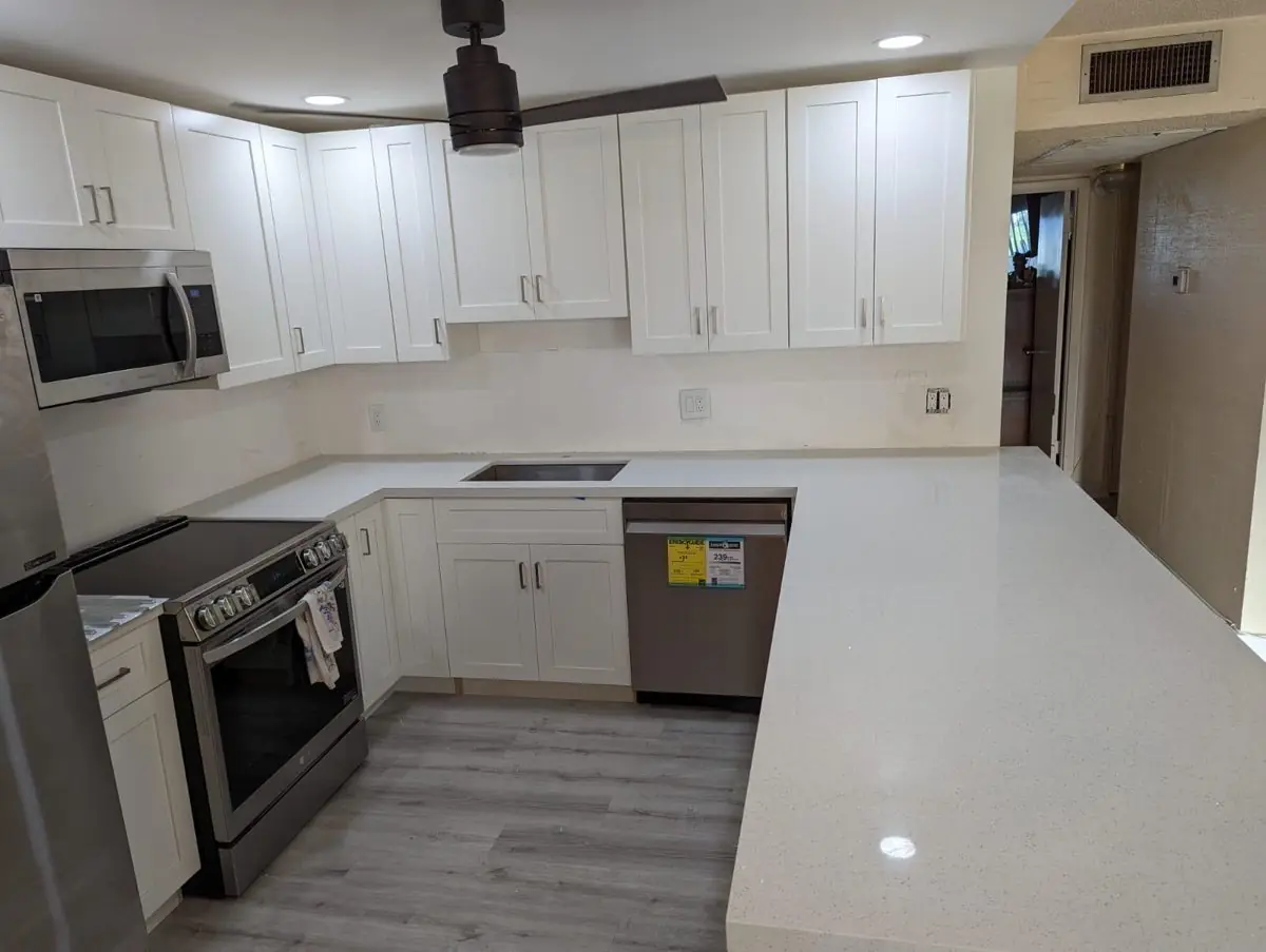 White shaker, matte-black hardware — Kitchen remodel by Proper Roofing
