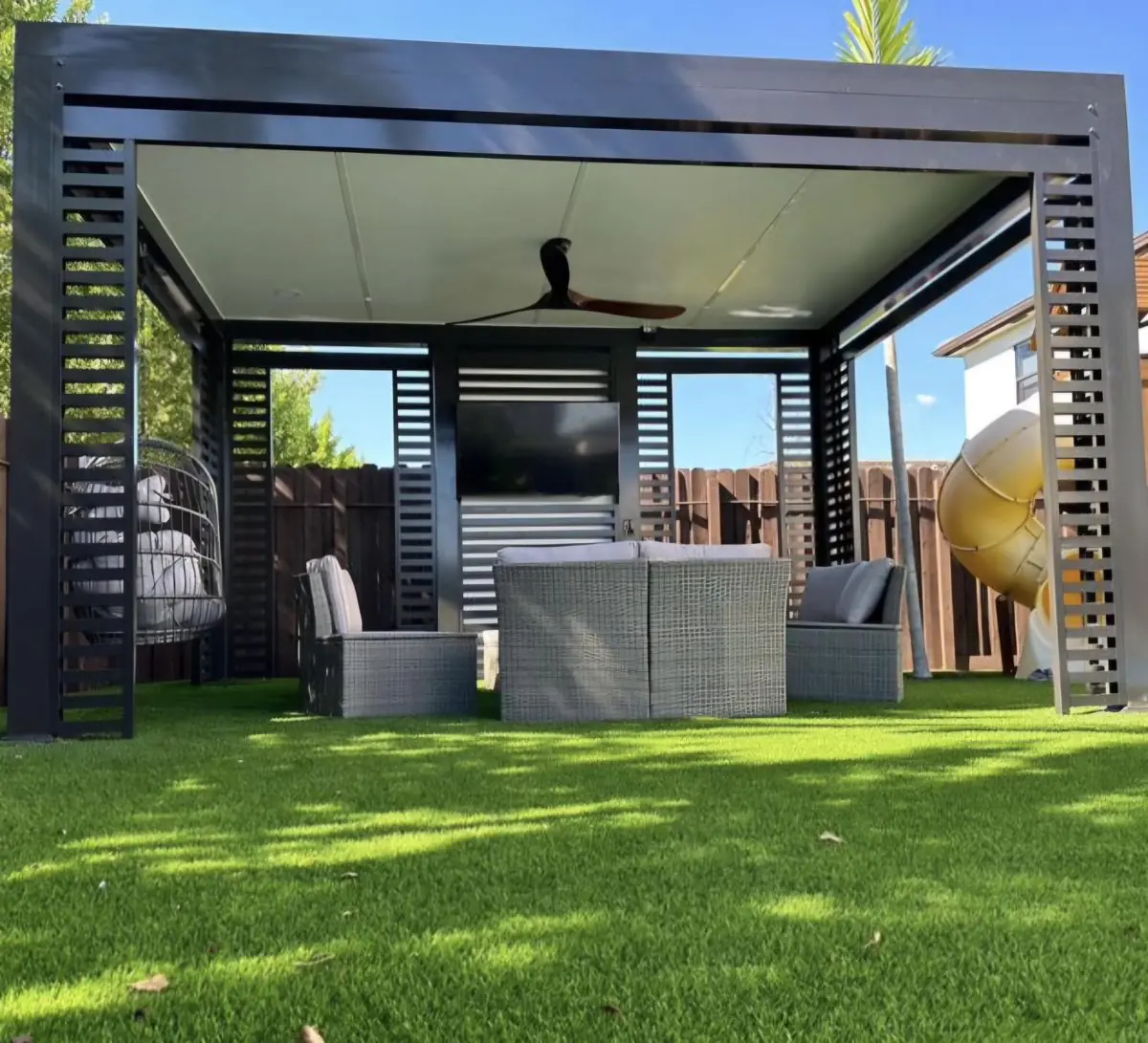 Pergola with slat wall and TV — Pergola by Proper Roofing