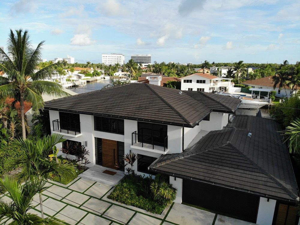 New flat tile roof on a two-story Miami home by Proper Roofing